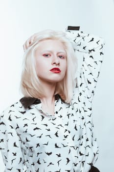portrait blonde albino girl in studio on white background.