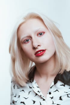 portrait blonde albino girl in studio on white background.