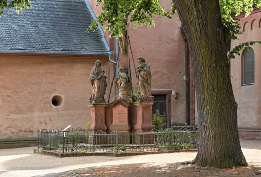 three sandstone sculptures in front of the church of st. marcellinus and peter, seligenstadt, hesse, germany