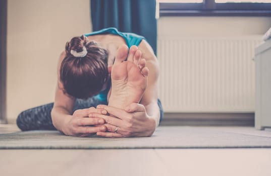 woman doing yoga at home