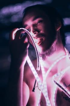 Portrait man Strip Light LED tape on dark color background.