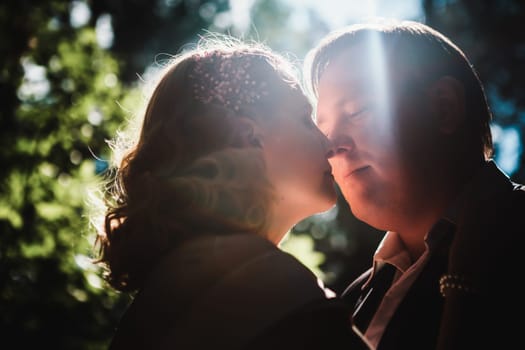 bride and groom on the background of trees and forest sun.