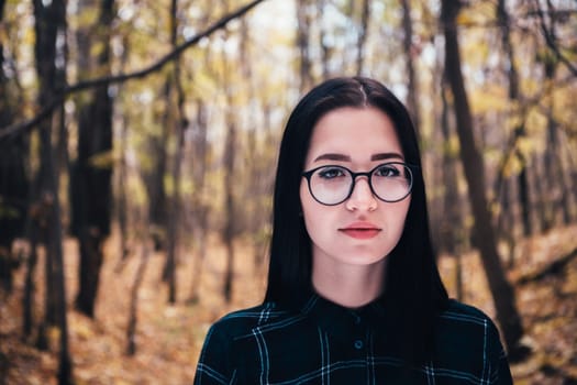 portrait of a young woman in the autumn forest.