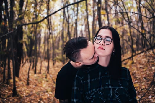 man and woman in the autumn forest