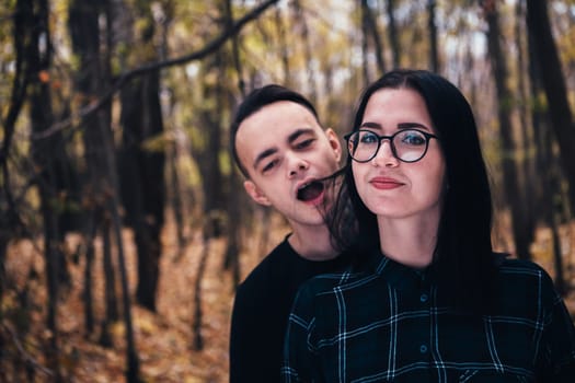 man and woman in the autumn forest