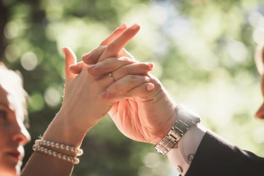 hands bride and groom on blurred background.