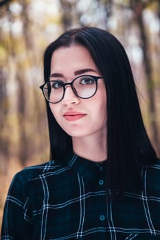 portrait of a young woman in the autumn forest.