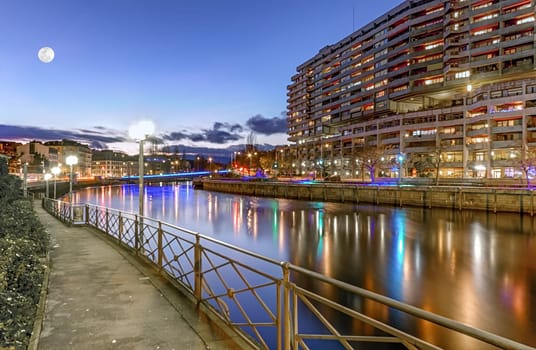 Rhone river, Sous-Terre bridge and buildings by night, Geneva, Switzerland, HDR