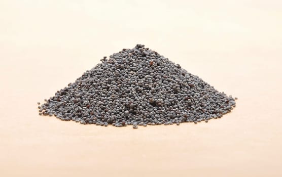 Poppy seeds on brown background