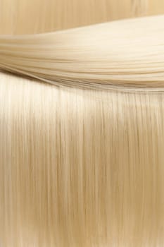 Closeup on luxurious straight glossy blonde hair