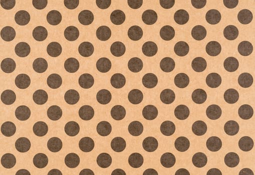 Brown craft paper with a black polka dot pattern