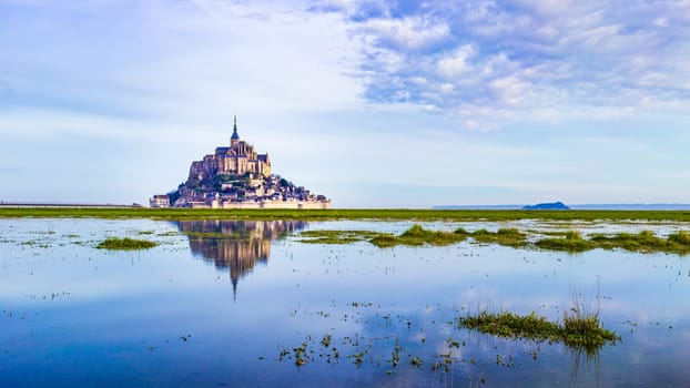Mont-Saint-Michel, deep blue water and clear reflections, Normandy, France
