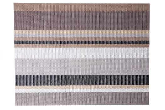 Plastic mats backgrounds. A woven plastic mat with a colorful striped pattern isolated on a white background.