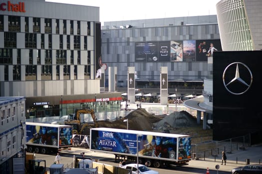 Berlin, Germany - November 06, 2018: Trucks with Mucialwerbung and construction vehicles of a construction site and pedestrians are in front of Mercedes-Benz Arena on 06 November 06, 2018 in Berlin.
