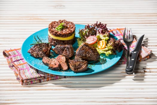 kangaroo steak with red rice and mango