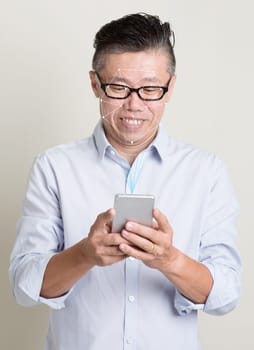 Futuristic and technology. Concept of scanning Asian man face with smartphone for facial recognition.