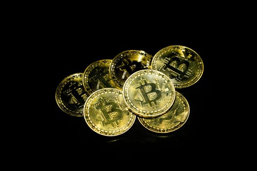 golden bitcoin cryptocurrency in dark background