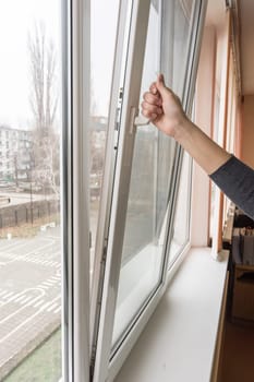 A hand opens a plastic window in a school class