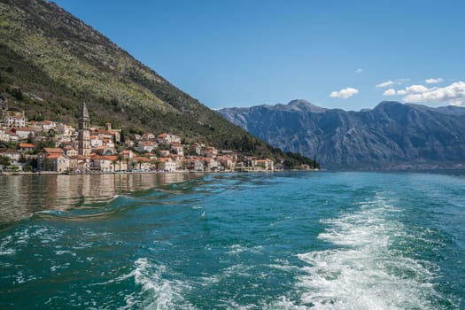 Picturesque small Perast town seen from the boat sailing in the Kotor Bay, Montenegro