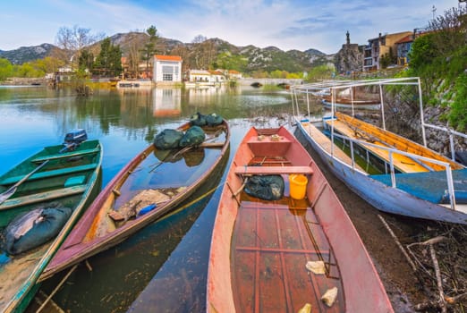 Neglected empty fisherman boats on the shore of lake Skadar in Virpazar, Montenegro