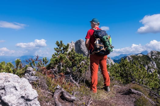 Hiker admire the mountain panorama of the peak
