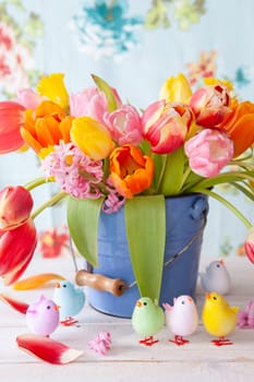 Colorful spring flowers in a little vintage bucket