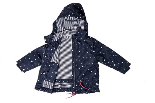 Kids jacket isolated. A stylish fashionable dark blue jacket with white dots and blue white striped lining for the little girl. A rain coat and windbreaker with hood for spring and autumn.
