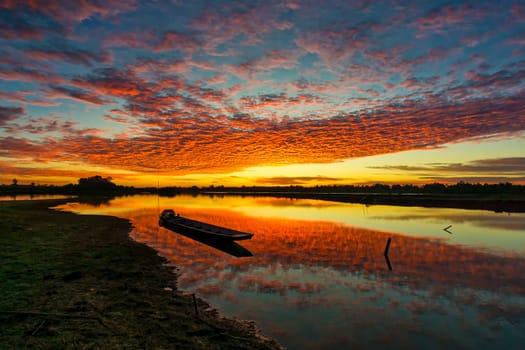 Sunrise With Lake Reflection, idyllic landscape with boat and cumulus clouds