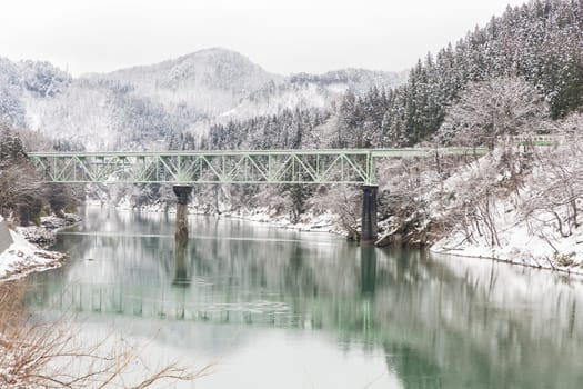 Train in Winter landscape snow on bridge
