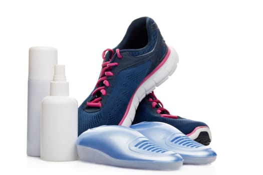 Sports shoes care. Electric shoes dryer with UV sterilization on a white background, Deodorant for shoe and antifungal agent. Shoe care products. Concept of healthy feet. Fitness and sport footwear
