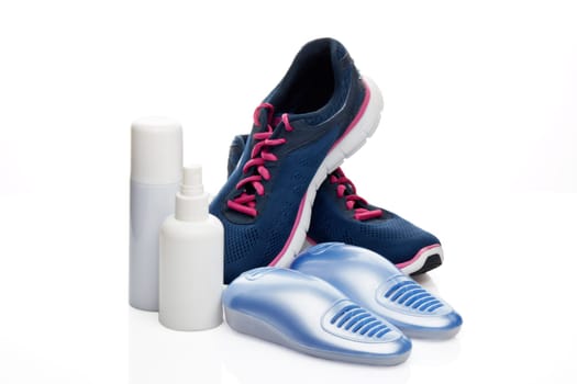 Sports shoes care. Electric shoes dryer with UV sterilization on a white background, Deodorant for shoe and antifungal agent. Shoe care products. Concept of healthy feet. Fitness and sport footwear