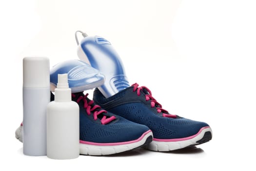 Sports shoes care. Electric shoes dryer with UV sterilization on a white background, Deodorant for shoe and antifungal agent. Shoe care products. Concept of healthy feet. Fitness and sport footwear