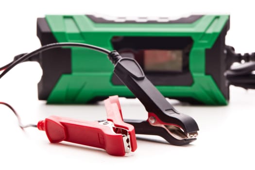 Smart multi purpose battery charger. Car battery charger isolated on a white background. Concept of service, maintenance, charging car battery, diy