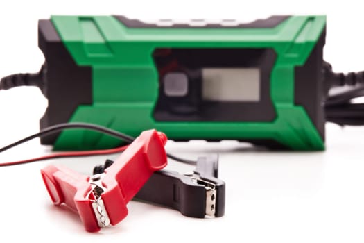 Smart multi purpose battery charger. Car battery charger isolated on a white background. Concept of service, maintenance, charging car battery, diy