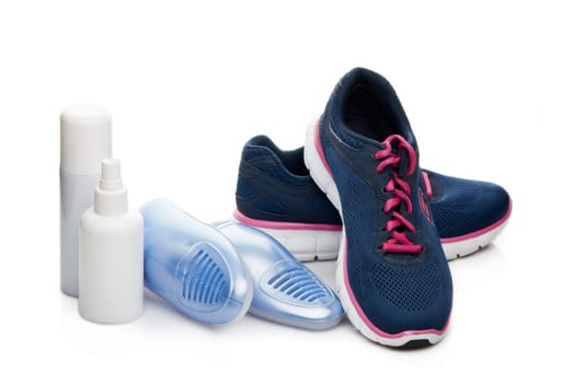 Sports shoes care. Electric shoes dryer with UV sterilization on a white background, Deodorant for shoe and antifungal agent. Shoe care products. Concept of healthy feet. Fitness and sport footwear