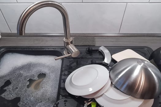 Wash and dry kitchen utensils on the sink by hand
