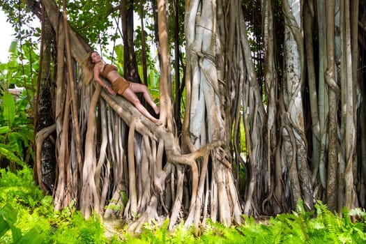 Wild woman climbing on trees