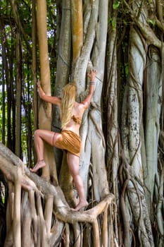 Wild woman climbing on trees
