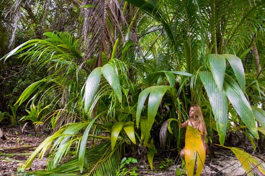 Wild woman hidden in the green jungle