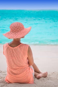 Girl in hat on coral beach