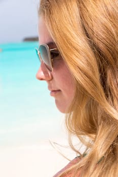 Young girl sunbathing on the beach