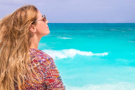 Gorgeous woman with blowing hair on the dream beach