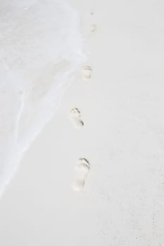 Human footprints by the sea