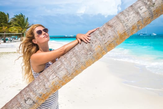 Blonde woman on the tropical beach