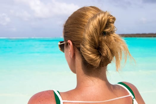 Young girl sunbathing on the beach