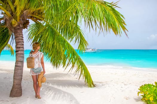Beautiful woman under palm tree