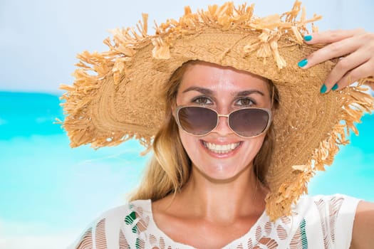 Gorgeous woman with sun hat on the dream beach