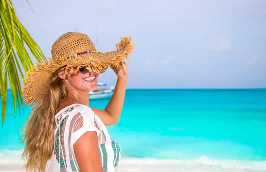 Gorgeous woman with sun hat on the dream beach
