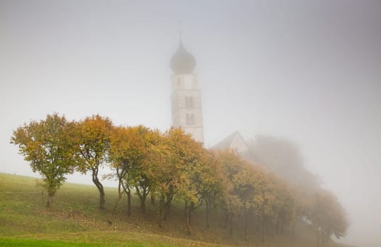 san Valentino church on a foggy late autumn day, Siusi allo Sciliar, Castelrotto, Dolomites, Italy