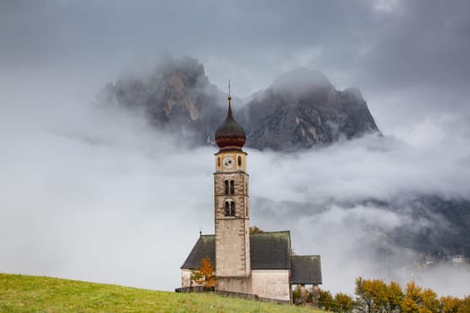 san Valentino church on a foggy late autumn day, Siusi allo Sciliar, Castelrotto, Dolomites, Italy